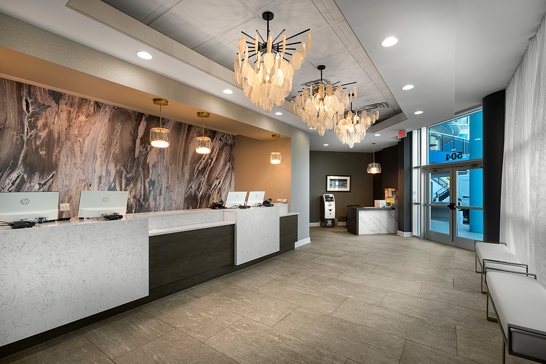 view of a man and woman working behind a front desk