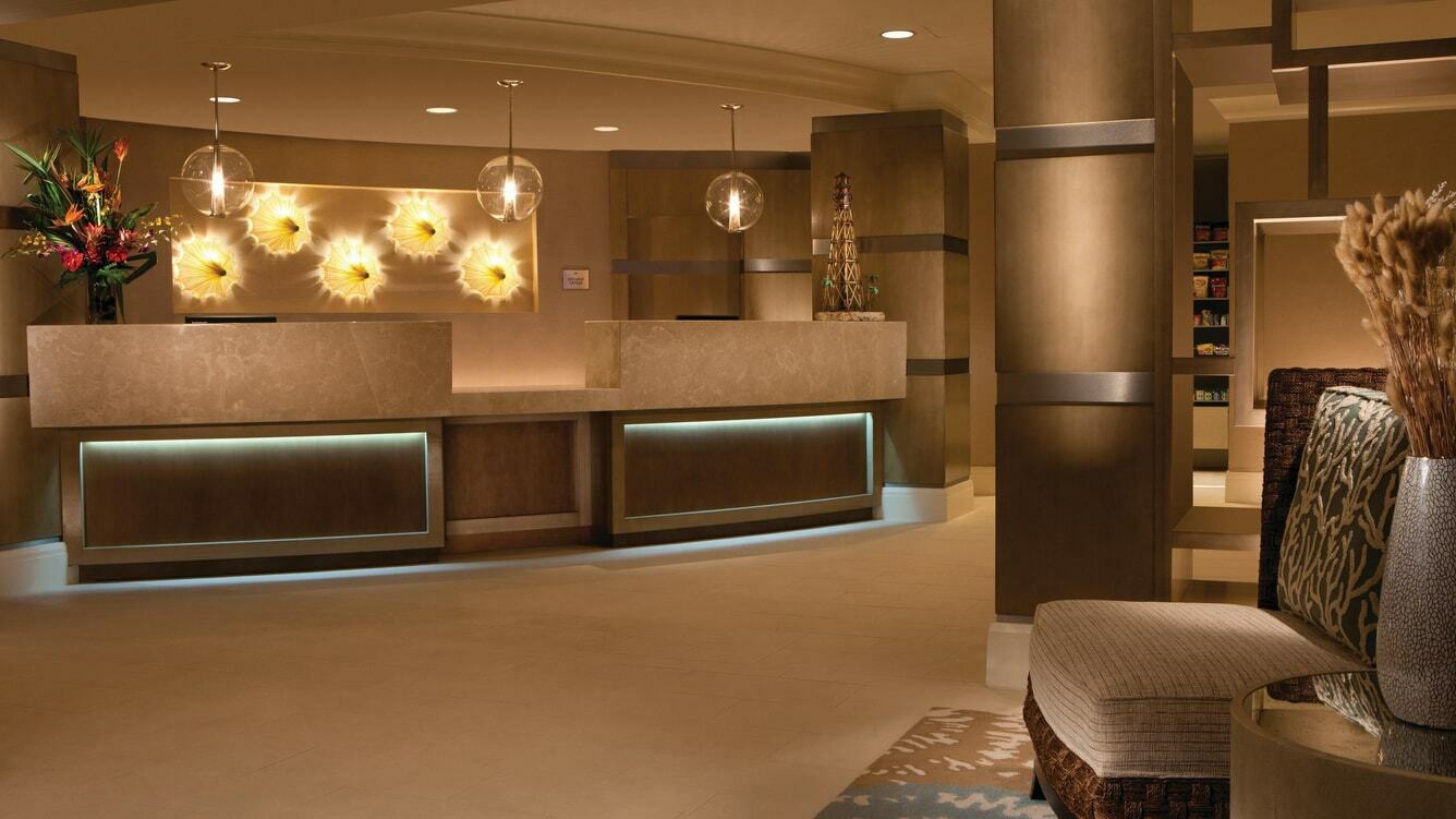 view of a man and woman working behind a front desk